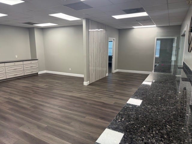 Open suite with granite counter and room divider, suitable for a growing team
