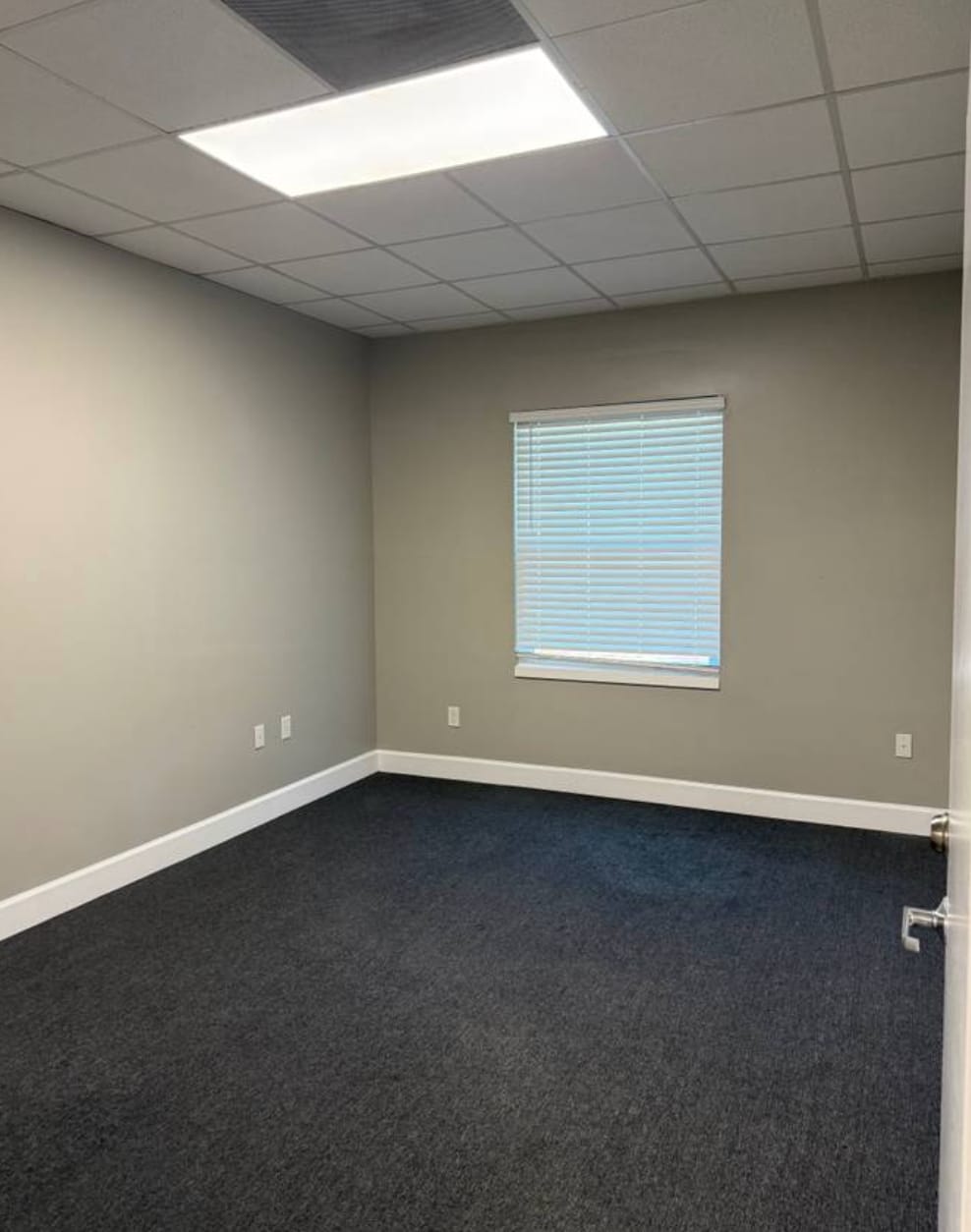 Bright private office with a window and neutral finishes, ready for a small business owner