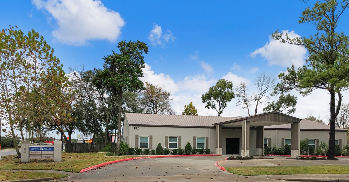 The Professional Building at 102 E Walker Street, League City — single-story professional office building with covered entry and monument sign